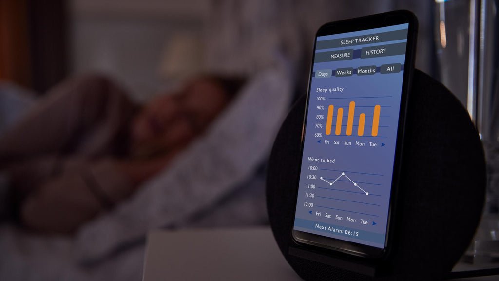 Image showing sleeper with a sleep tracker on the bedside table