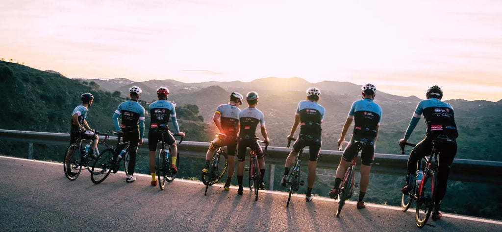 Group of 8 friends biking and stopping to take in the sunrise.