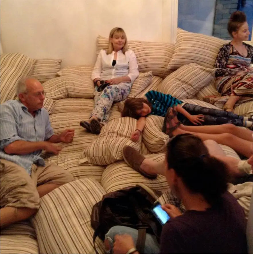People of all ages relaxing on Essentia pillows at a showroom event