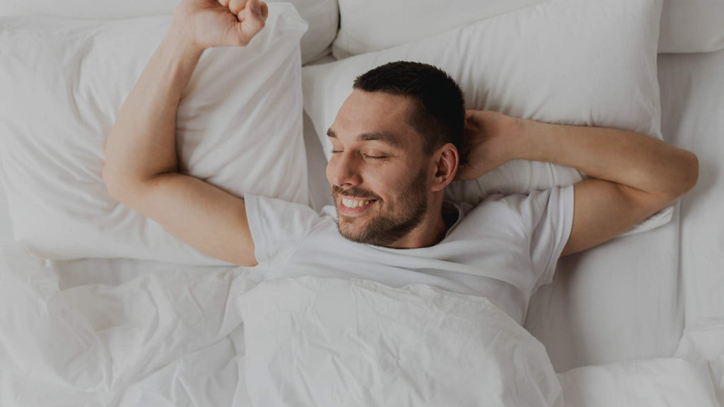 Man smiling as he wakes up.