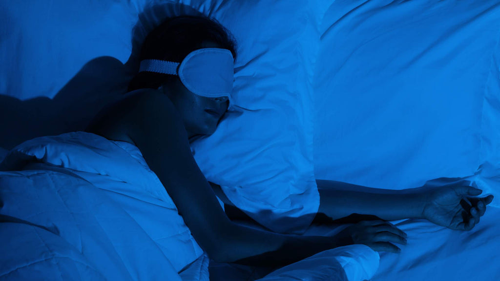 Woman asleep at night wearing a sleep mask