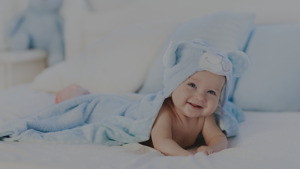 Baby smiling while on the a mattress