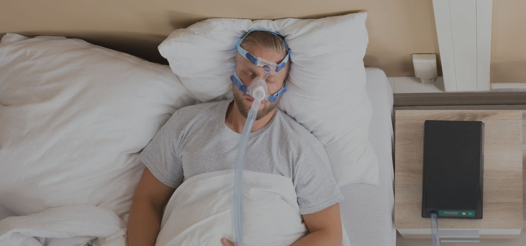 Man sleeping with a CPAP machine