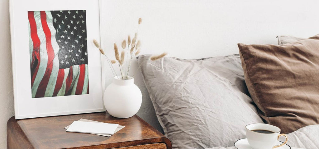 Clean bedroom featuring an image of the American Flag on the nightstand.