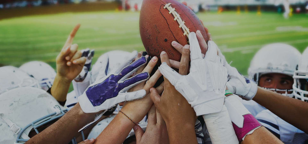 Football players celebrating and holding football