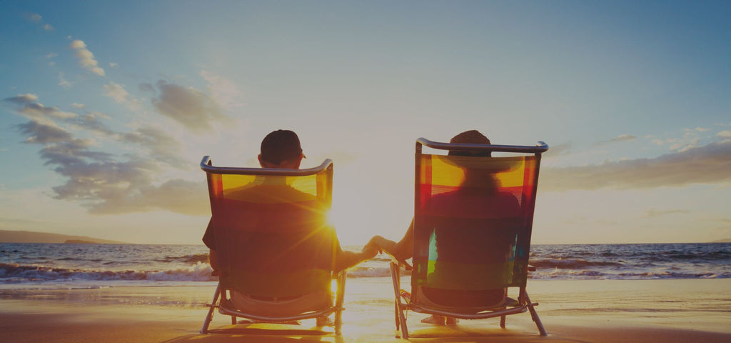 Couple enjoying the sunset on the beach during their summer vacation