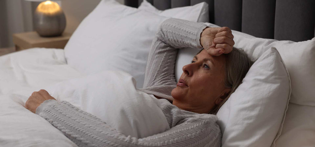 Woman waking up in the middle of the night hot and sweating