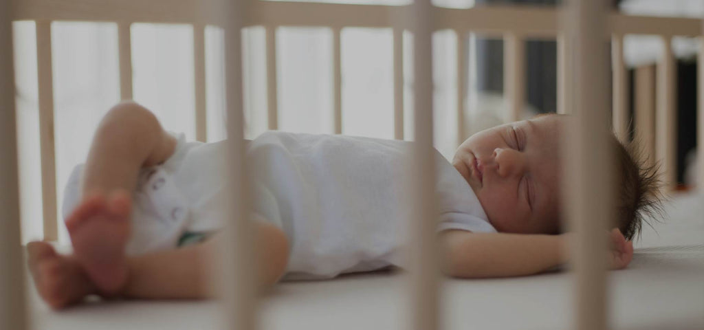 baby sleeping in his crib