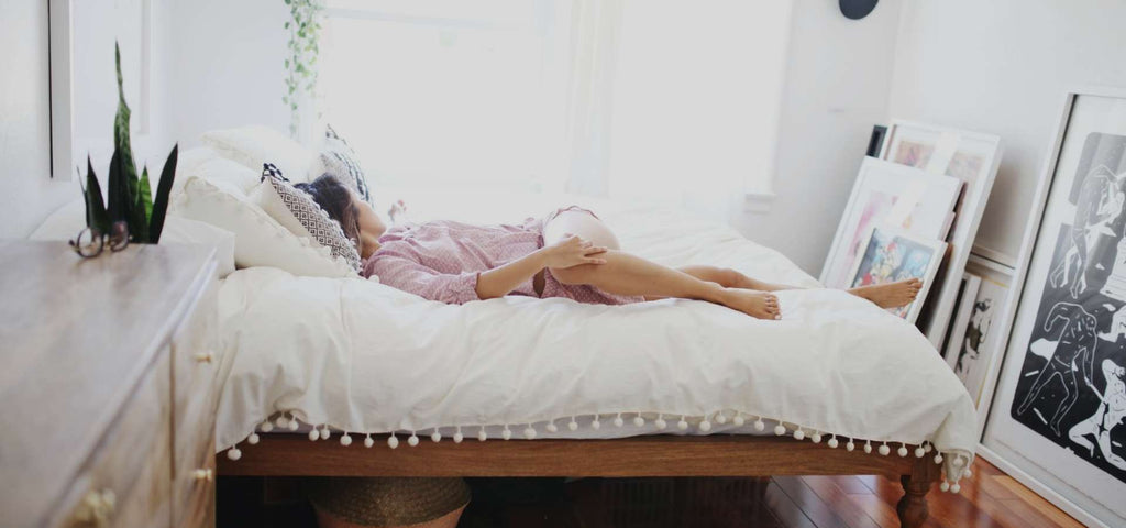 Woman stretching while in bed