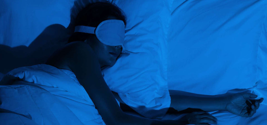 Woman sleeping soundly wearing a sleep mask in a cold room