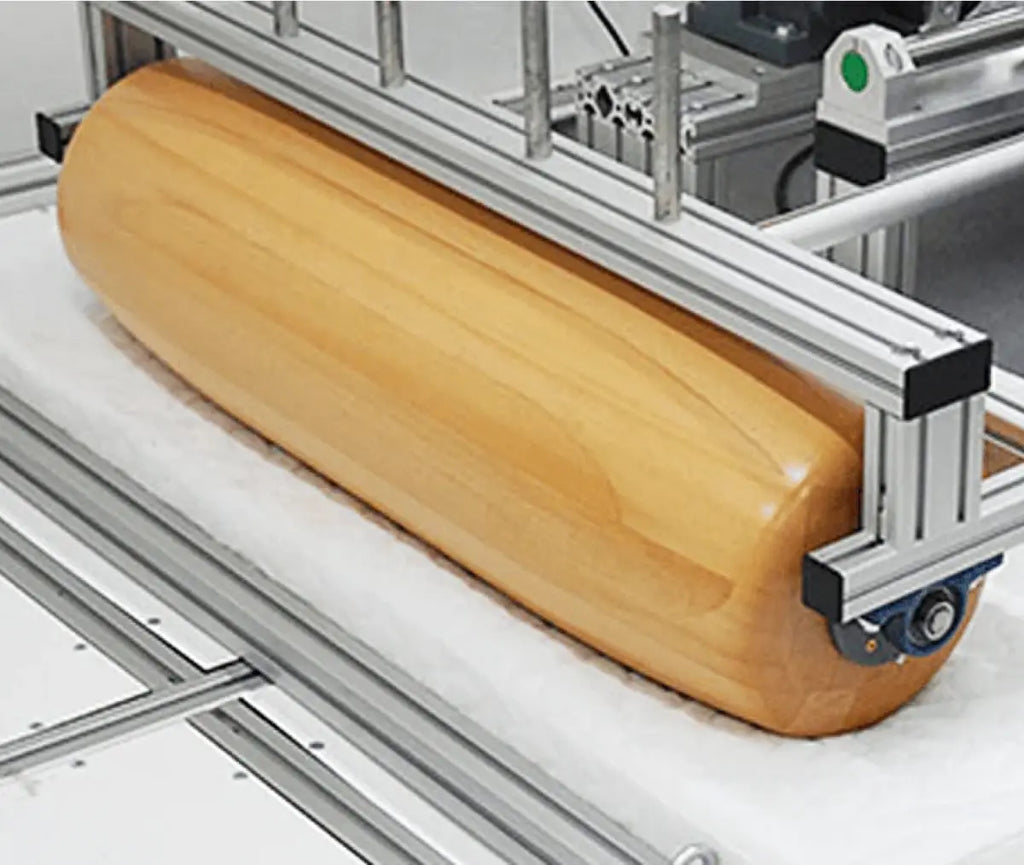 Essentia foam being tested for longevity with a giant wooden roller machine
