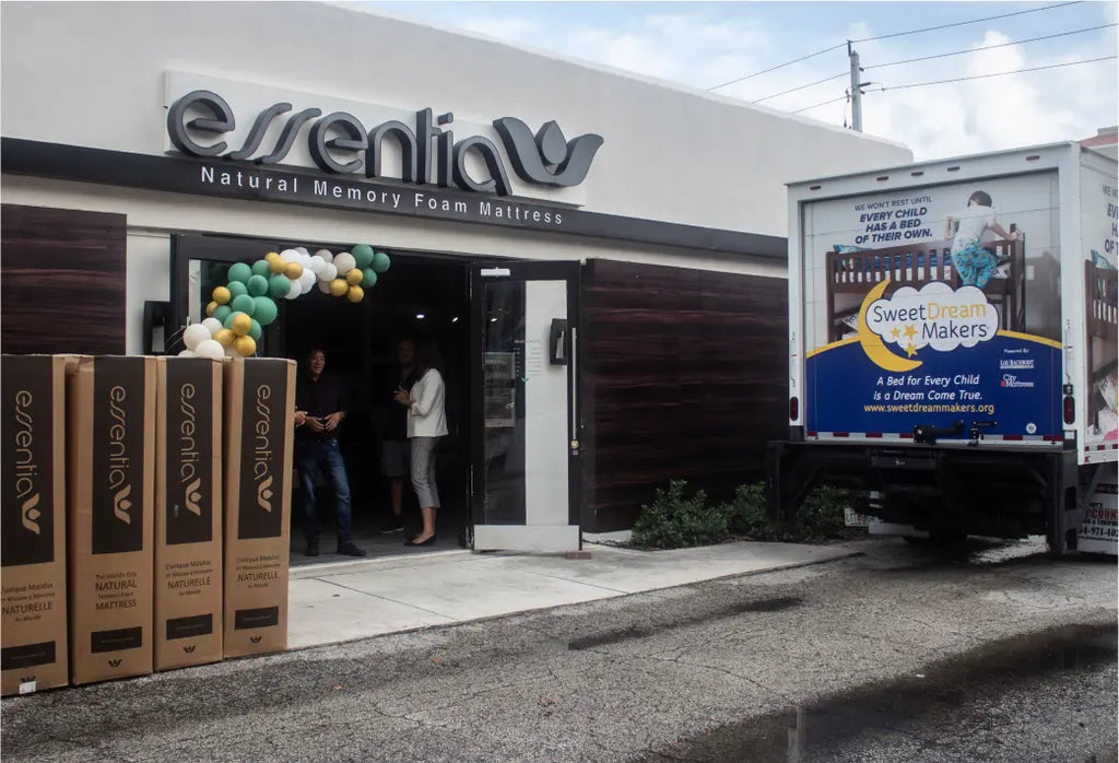 Sweet Dream Makers picking up Essentia donations in a truck from the Boca Raton showroom. Mattresses are lined up outside the showroom.