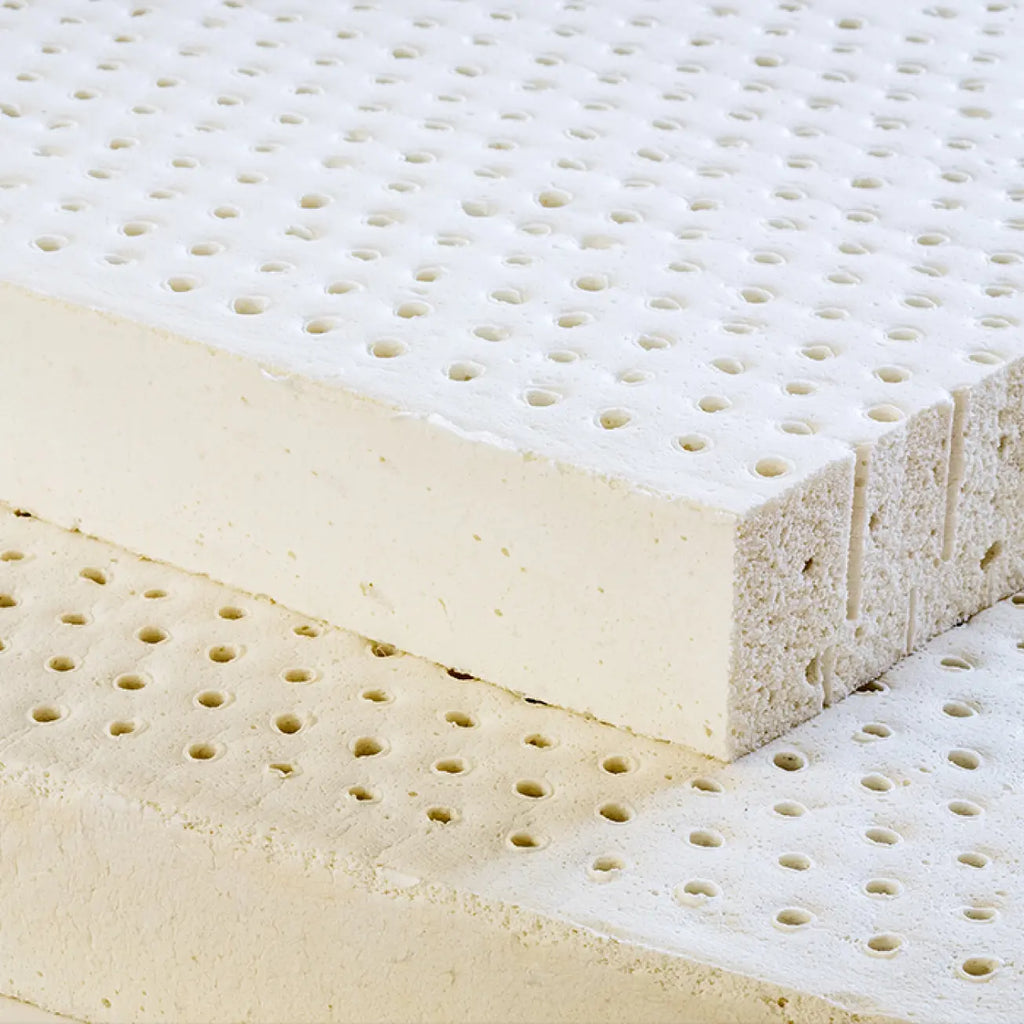 Slabs of Essentia certified organic foam sit on top of each other. Each slab has holes for added comfort.