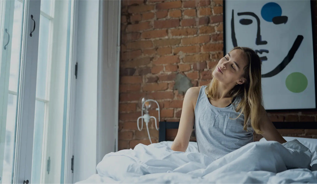 A young woman wakes up to a new day refreshed from her Essentia Mattress.
