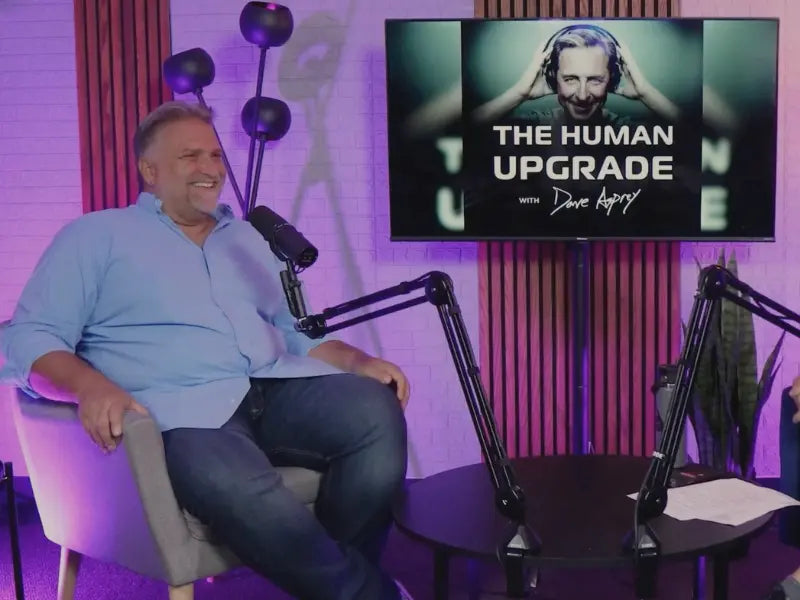 Jack Dell'Accio, Certified Sleep Coach and CEO & Founder of Essentia, smiling while recording Dave Asprey's Human Upgrade Podcast