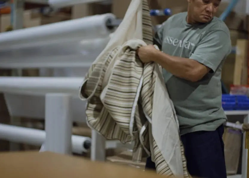 Man working in the Essentia factory making a mattress.
