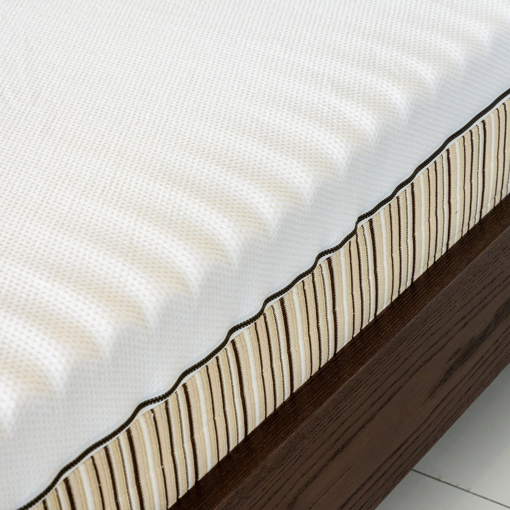 Essentia Stratami mattress side close up on the Meda wood bed frame