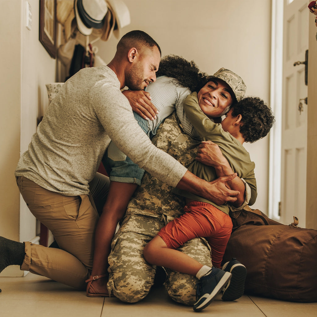 Family embracing as their mother returned home from serving in the army