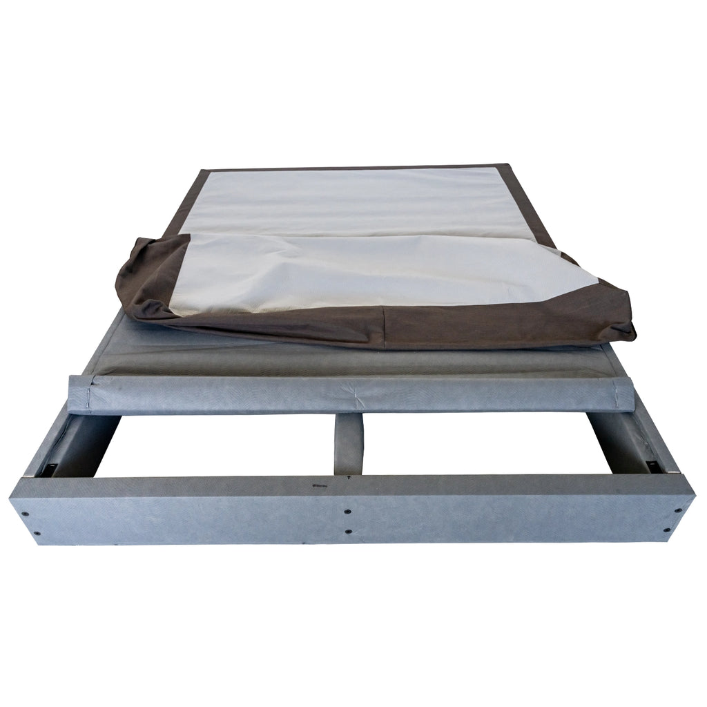 Low-profile large platform bed frame with light blue-gray mattress cover on dark fabric base.