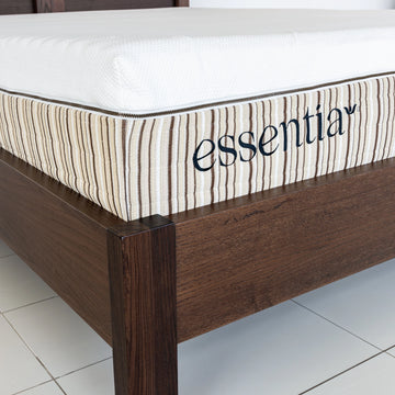 Essentia mattress shown on a Tosca wood bed frame, close up of the corner.