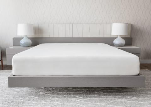 Stay Well Mattress by Essentia show in a hotel room covered with sheets