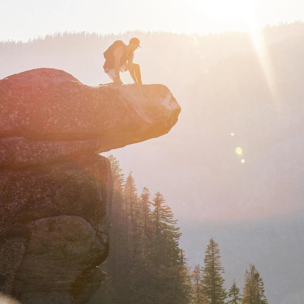 Mountain climber at the top of a cliff